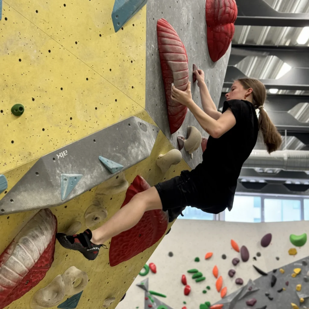 A student on an indoor climbing wall.