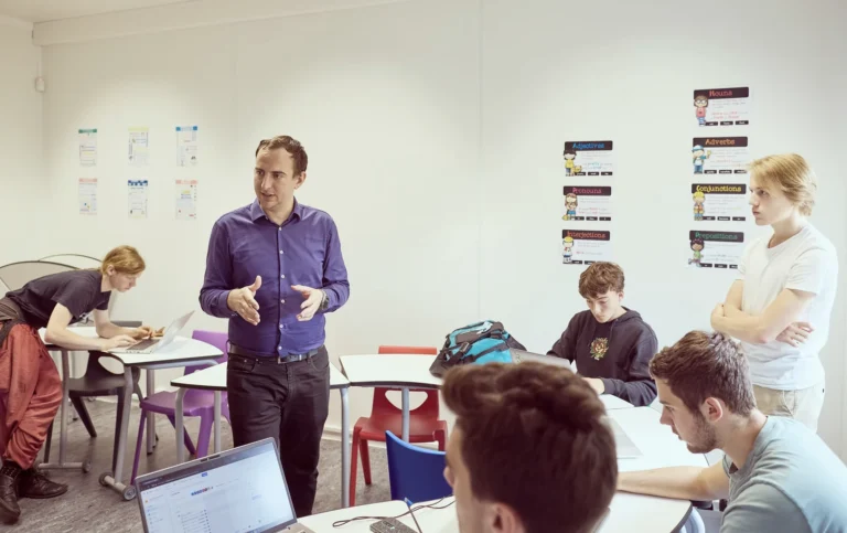 A teacher discussing with students in the classroom
