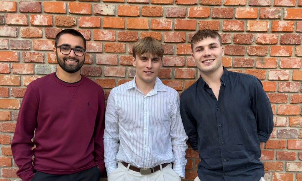 The MediVox team in front of a brick wall